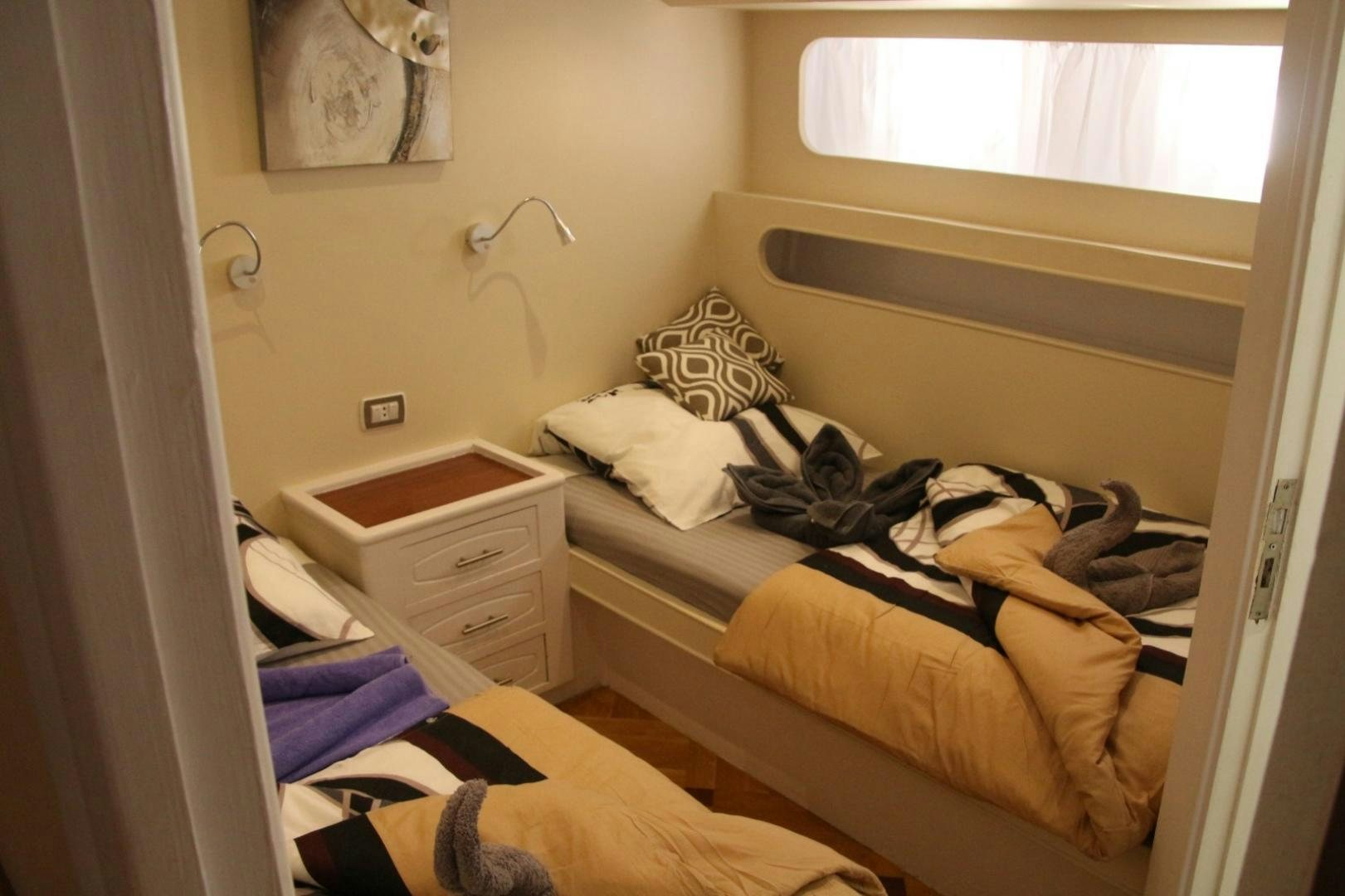 a bedroom with a couple of beds aboard SIM SIM Yacht for Sale