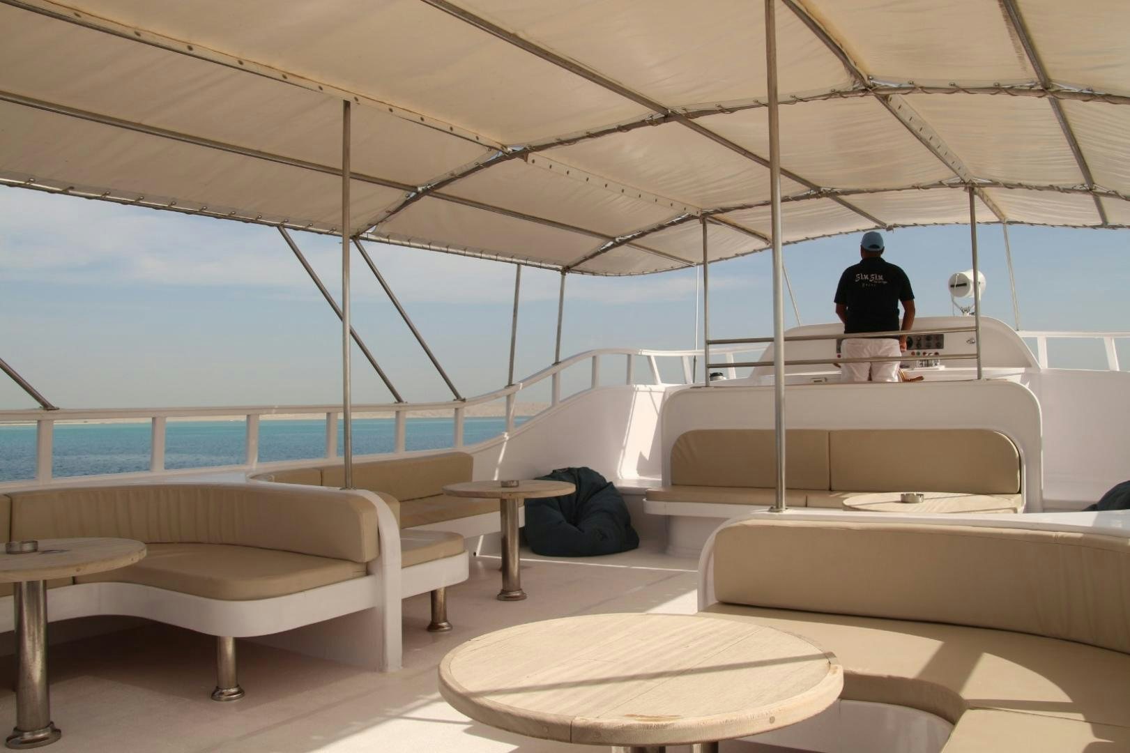 a person sitting on a couch aboard SIM SIM Yacht for Sale