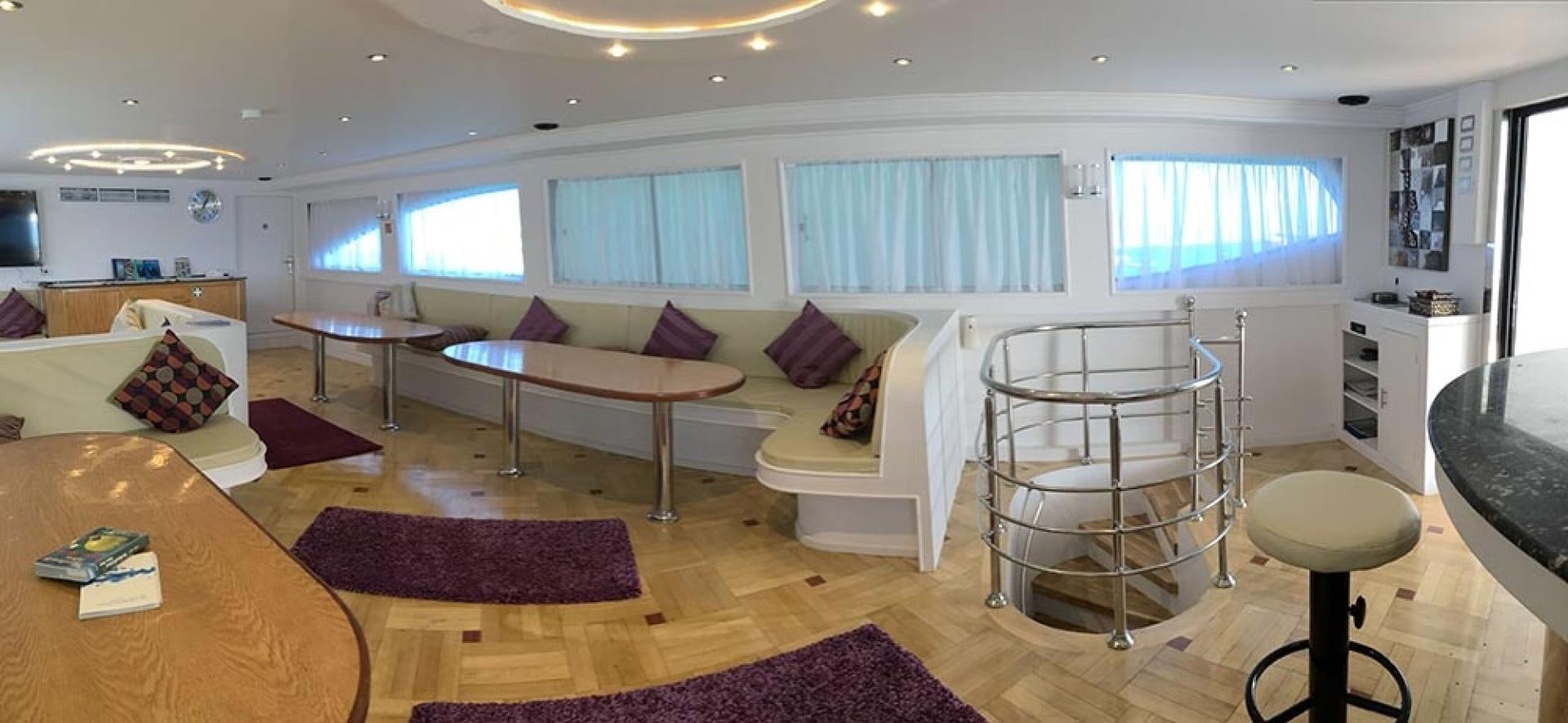 a living room with a couch and a table aboard SIM SIM Yacht for Sale