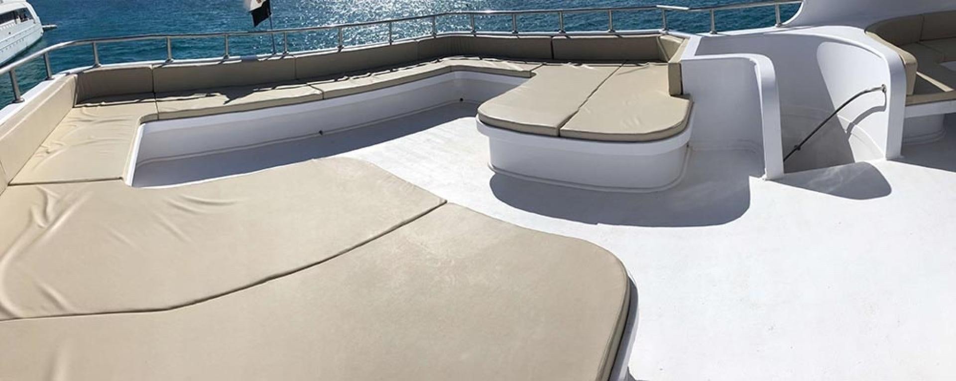 a white boat on a deck aboard SIM SIM Yacht for Sale