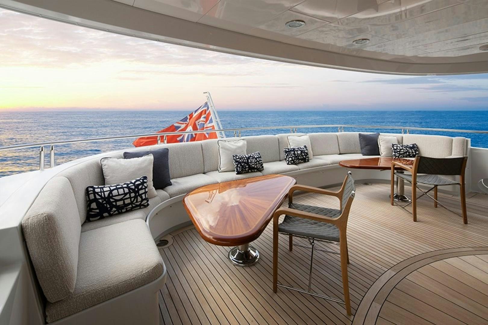 a lounge area with chairs and a large body of water in the background aboard BACCHUS "NAME RESERVED" Yacht for Sale