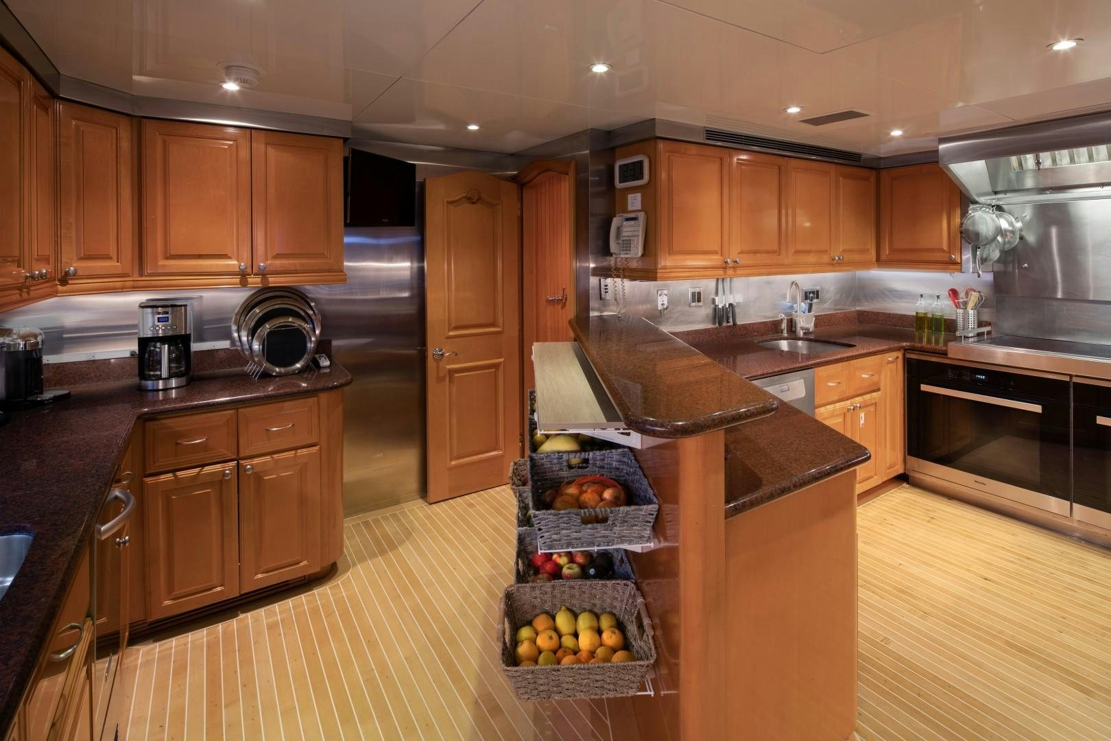 a kitchen with wooden cabinets aboard BACCHUS "NAME RESERVED" Yacht for Sale