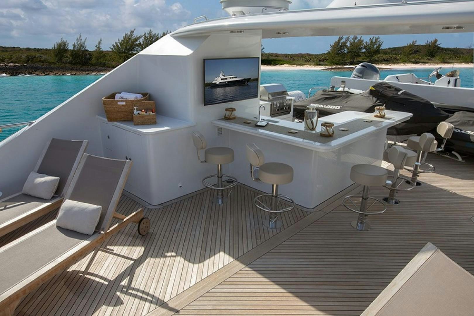 a deck with chairs and tables on it next to a body of water aboard BACCHUS "NAME RESERVED" Yacht for Sale
