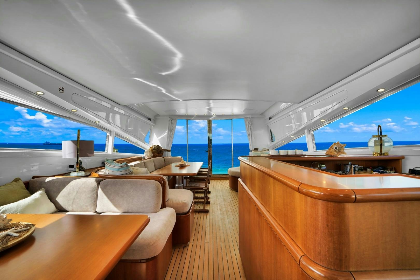 a room with a couch and a table and a large window aboard CHURRI Yacht for Sale