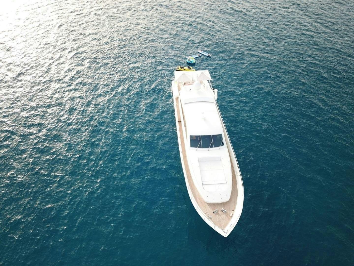 a small white boat in the water aboard CHURRI Yacht for Sale