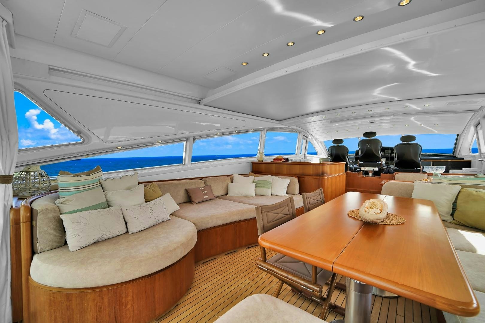 a room with a table and couches aboard CHURRI Yacht for Sale