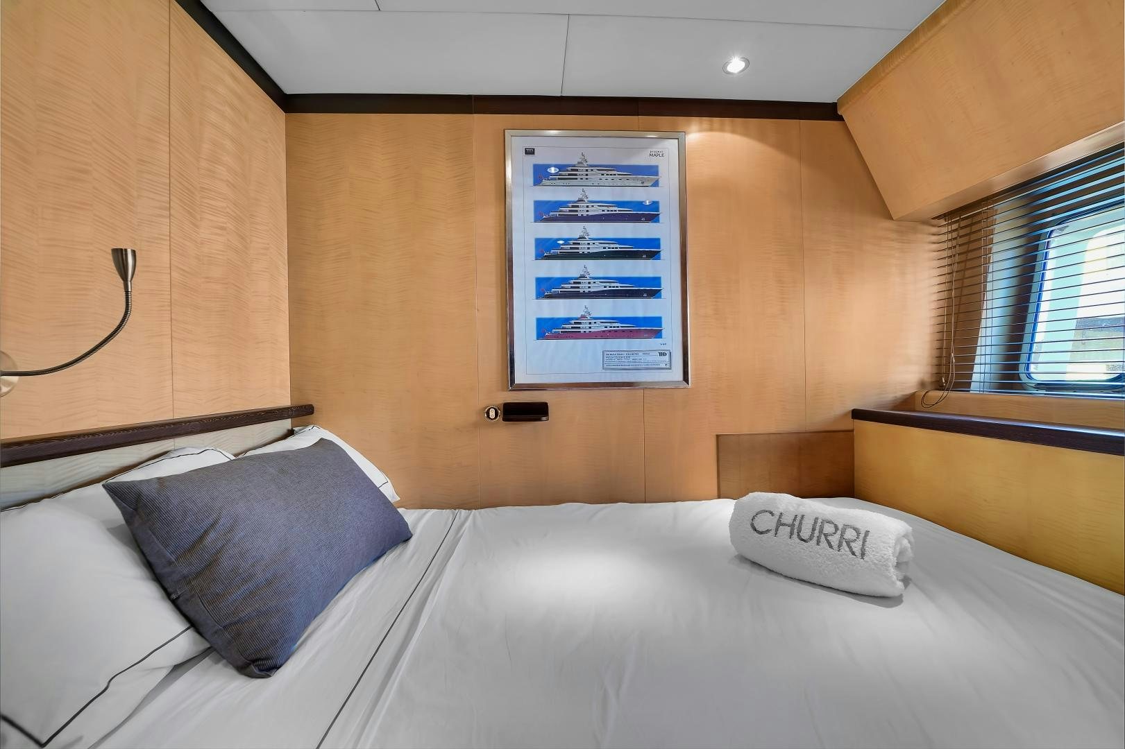 a bed with a blue pillow aboard CHURRI Yacht for Sale