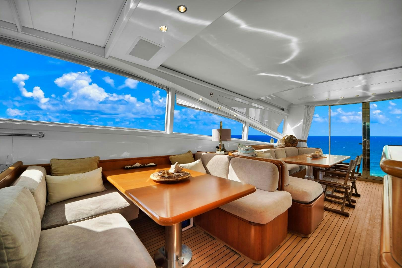 a room with a table chairs and a large window aboard CHURRI Yacht for Sale