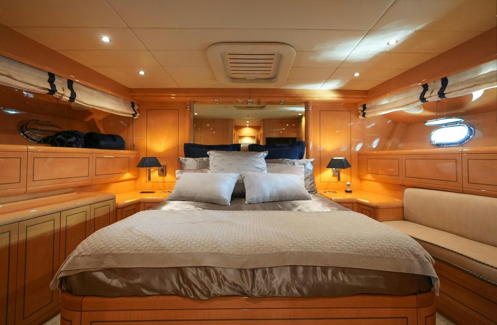 a room with a bed and a lamp aboard QUERENCIA Yacht for Sale