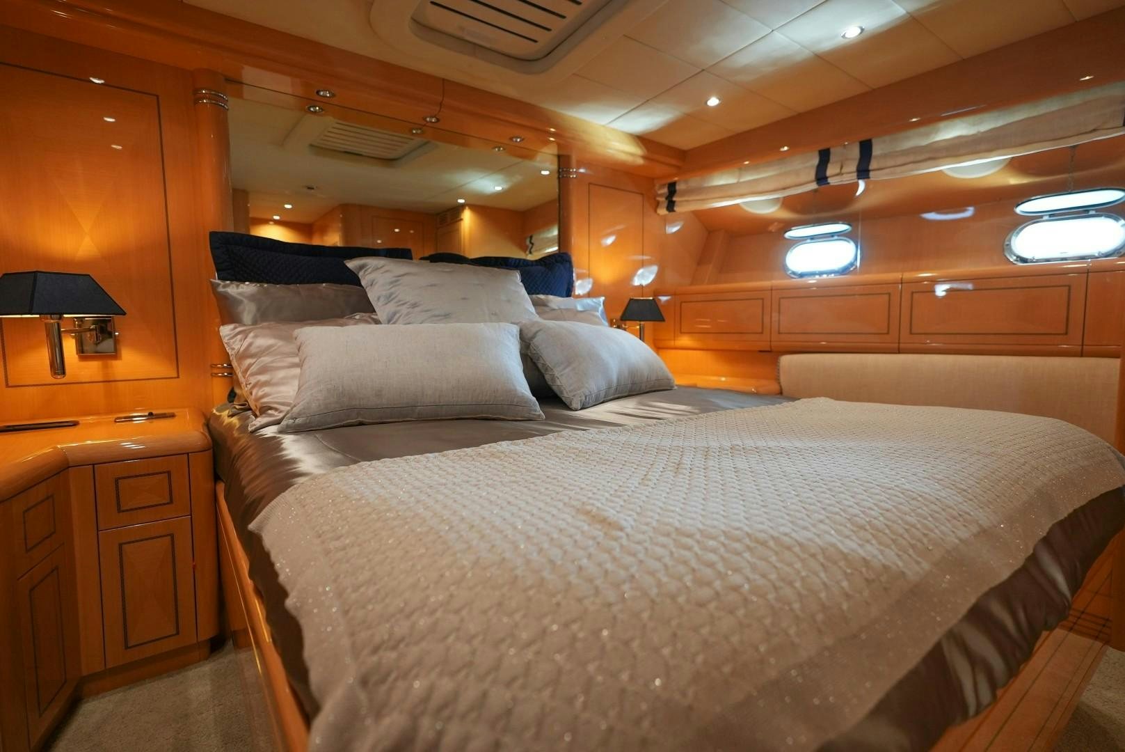 a bed with a white comforter aboard QUERENCIA Yacht for Sale