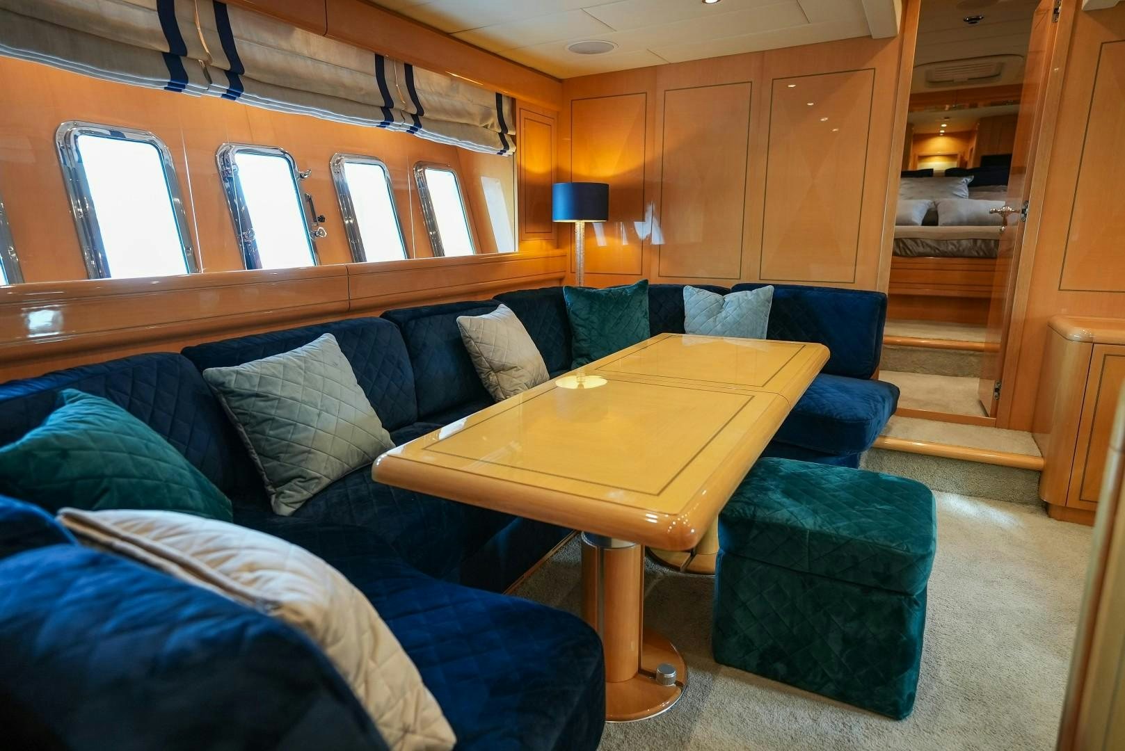 a living room with a couch and a table aboard QUERENCIA Yacht for Sale