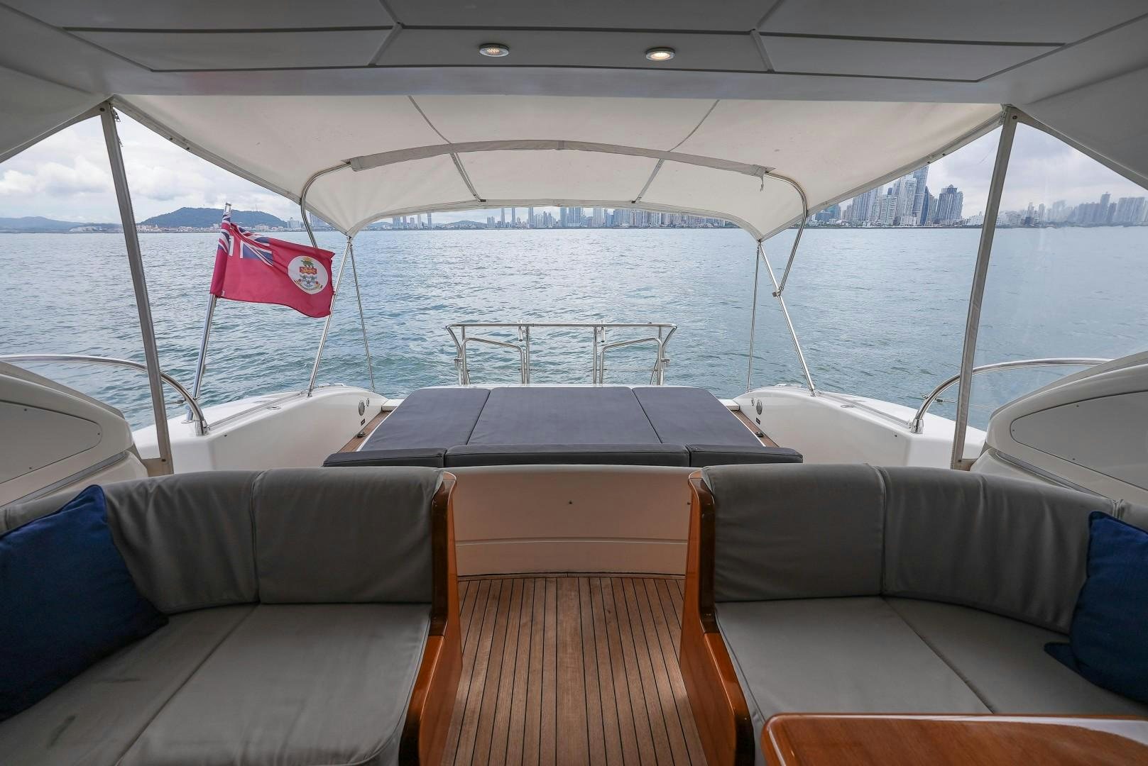 a boat with a flag on the front aboard QUERENCIA Yacht for Sale
