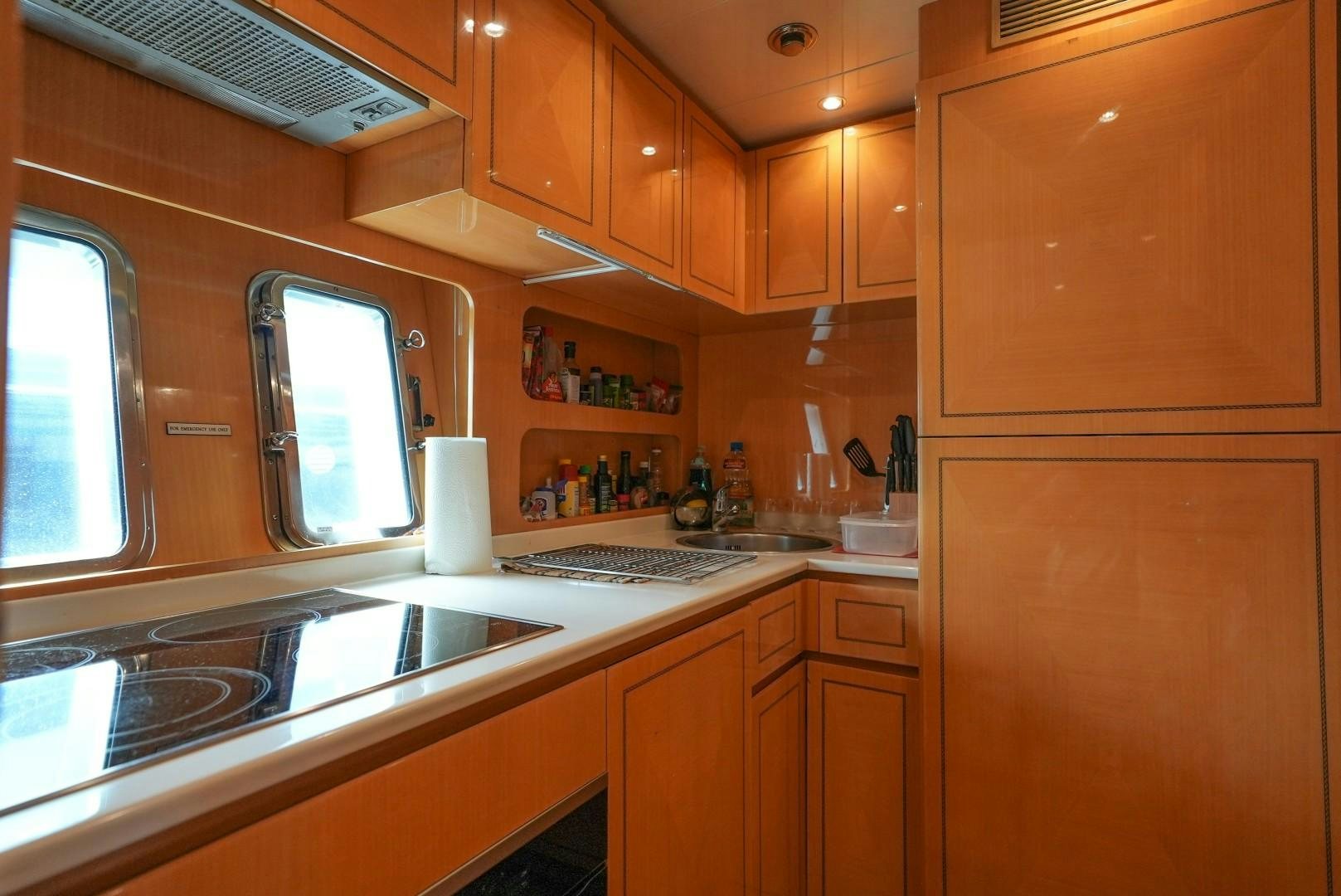 a kitchen with wooden cabinets aboard QUERENCIA Yacht for Sale