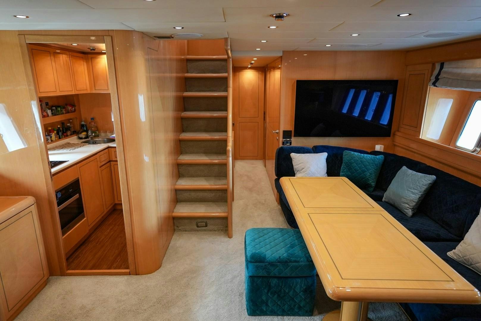 a living room with a couch and a tv aboard QUERENCIA Yacht for Sale