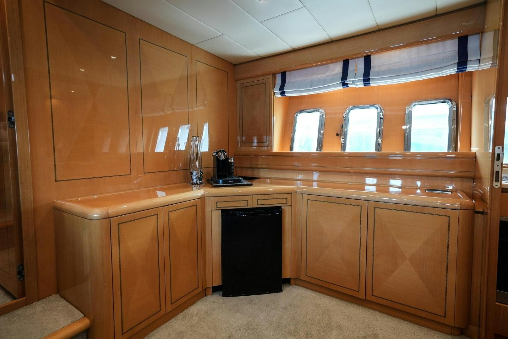 a kitchen with wooden cabinets aboard QUERENCIA Yacht for Sale