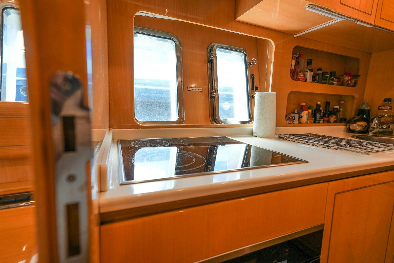 a kitchen with a microwave oven and a sink aboard QUERENCIA Yacht for Sale