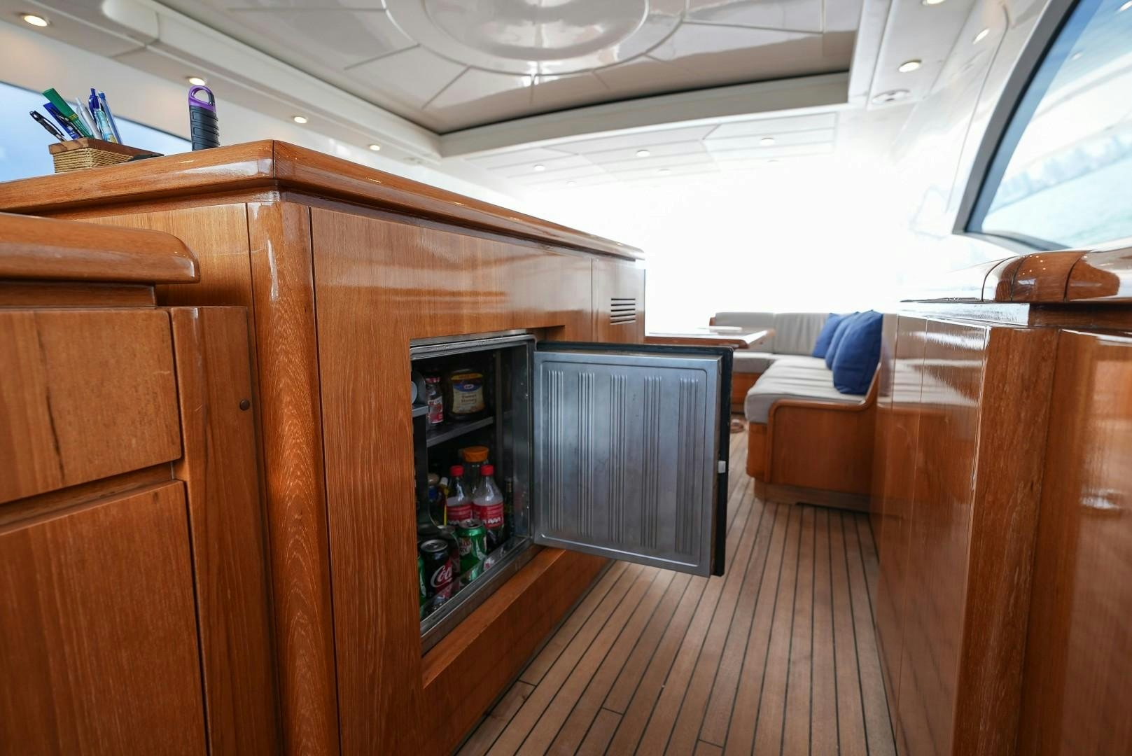 a room with a wood cabinet and a shelf with bottles on it aboard QUERENCIA Yacht for Sale