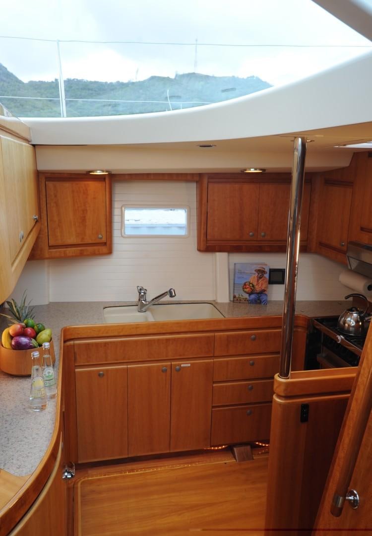 a kitchen with wooden cabinets aboard SIRONA Yacht for Sale