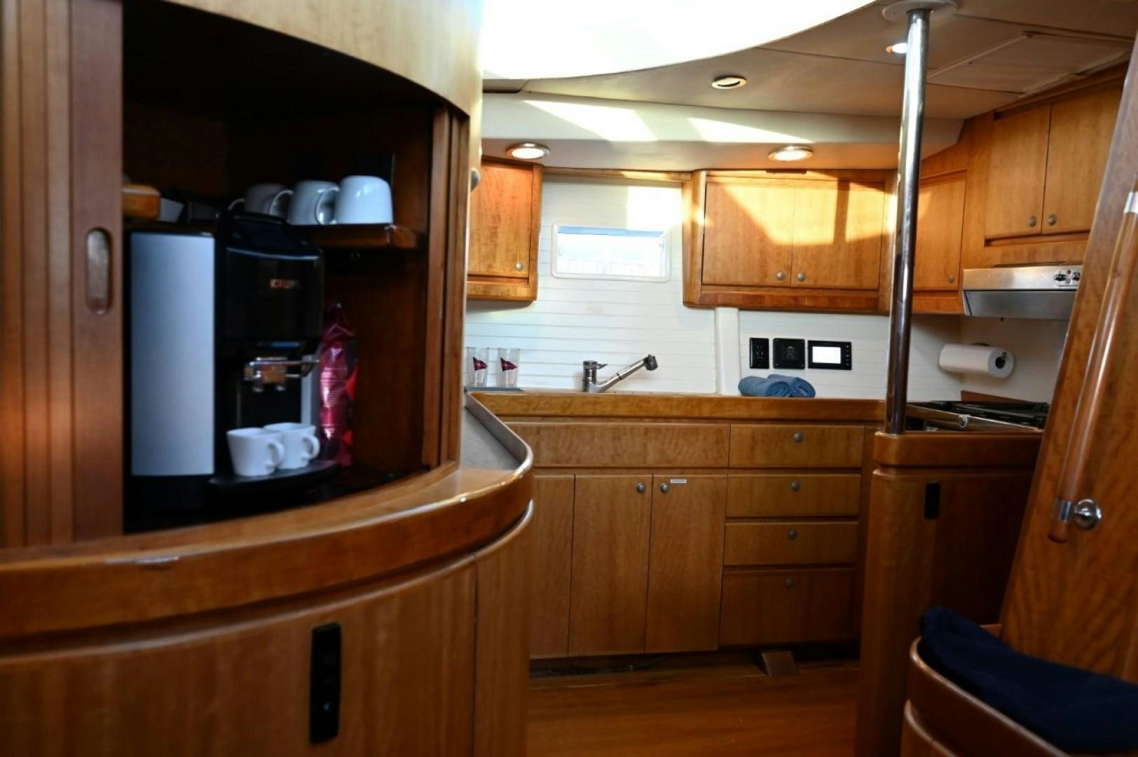 a kitchen with wooden cabinets aboard SIRONA Yacht for Sale