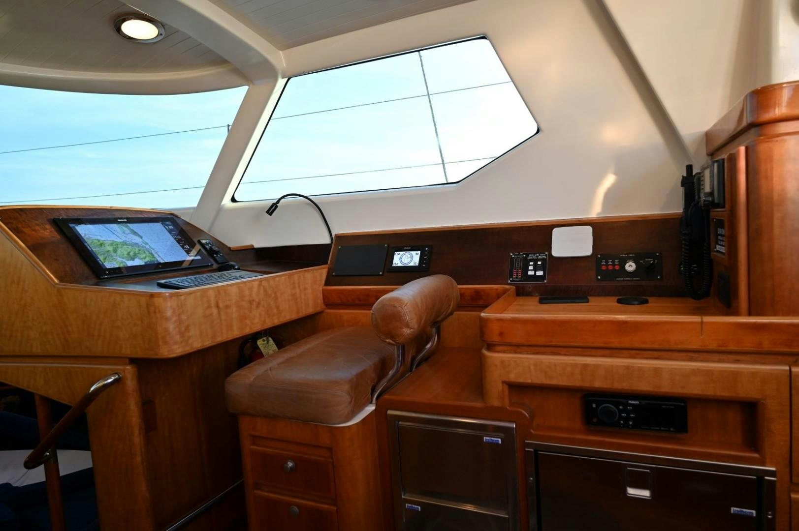 a desk with a laptop and a phone on it aboard SIRONA Yacht for Sale