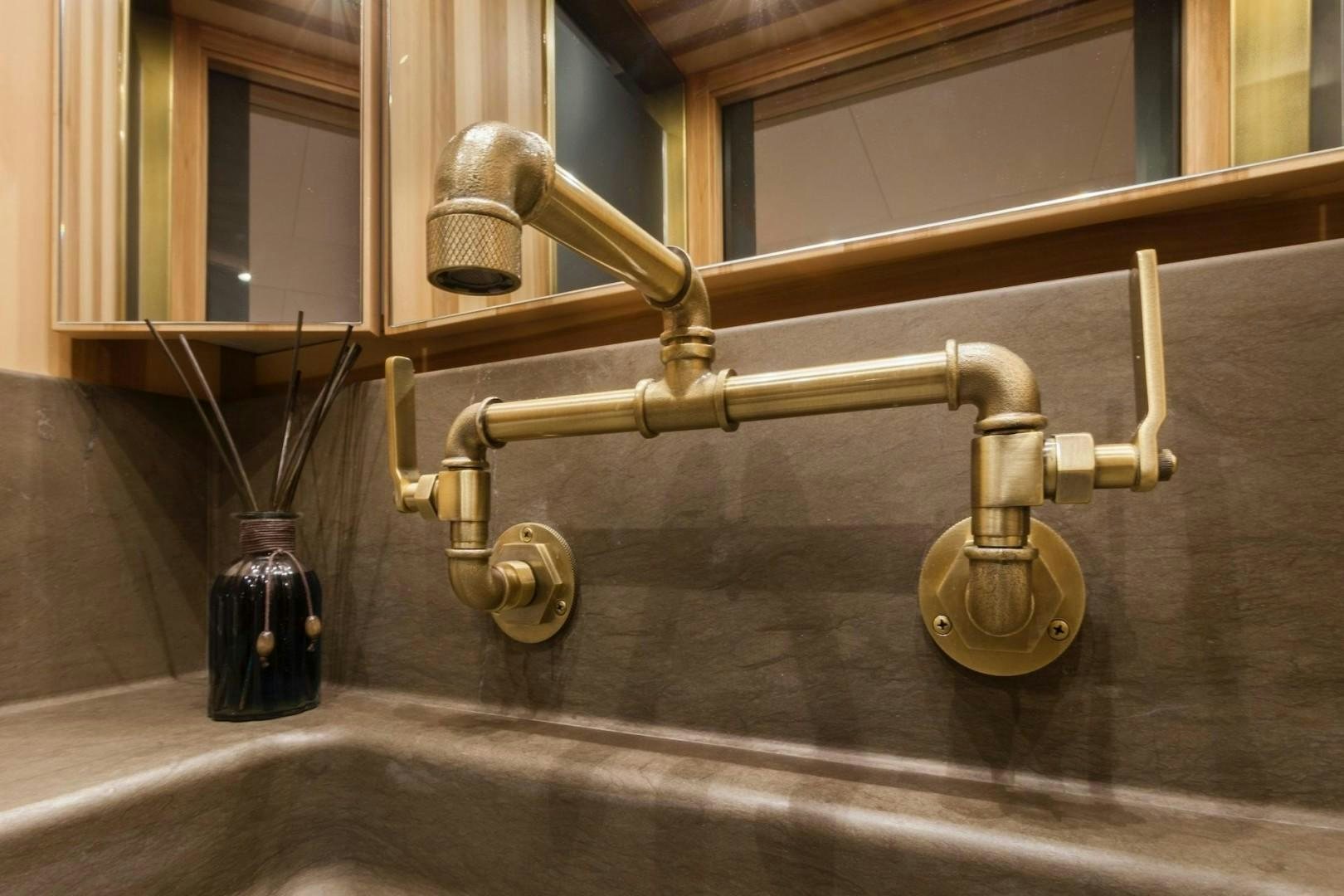 a brass faucet with a metal handle and a metal handle aboard ACALA Yacht for Sale