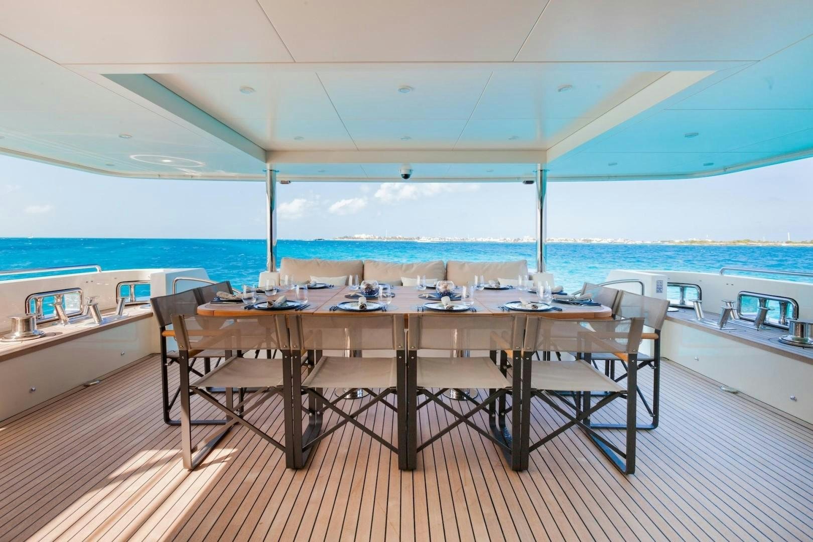 a table with chairs on a deck aboard ACALA Yacht for Sale