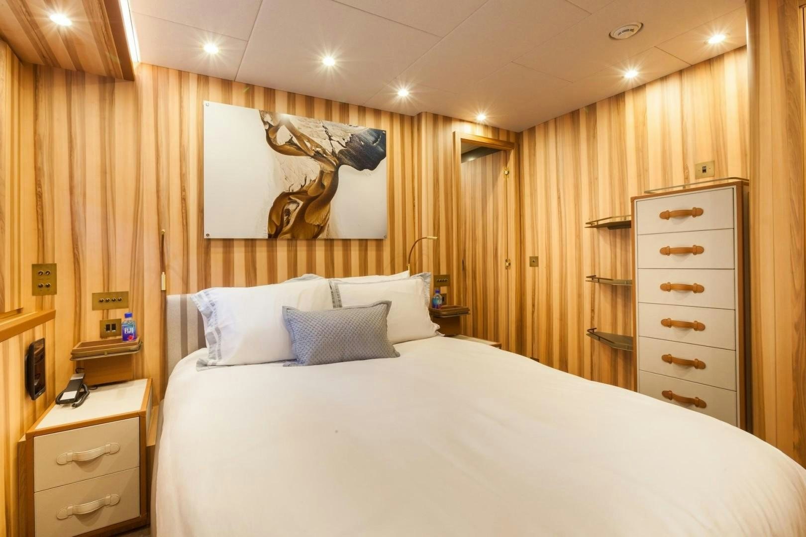 a bed with white sheets aboard ACALA Yacht for Sale