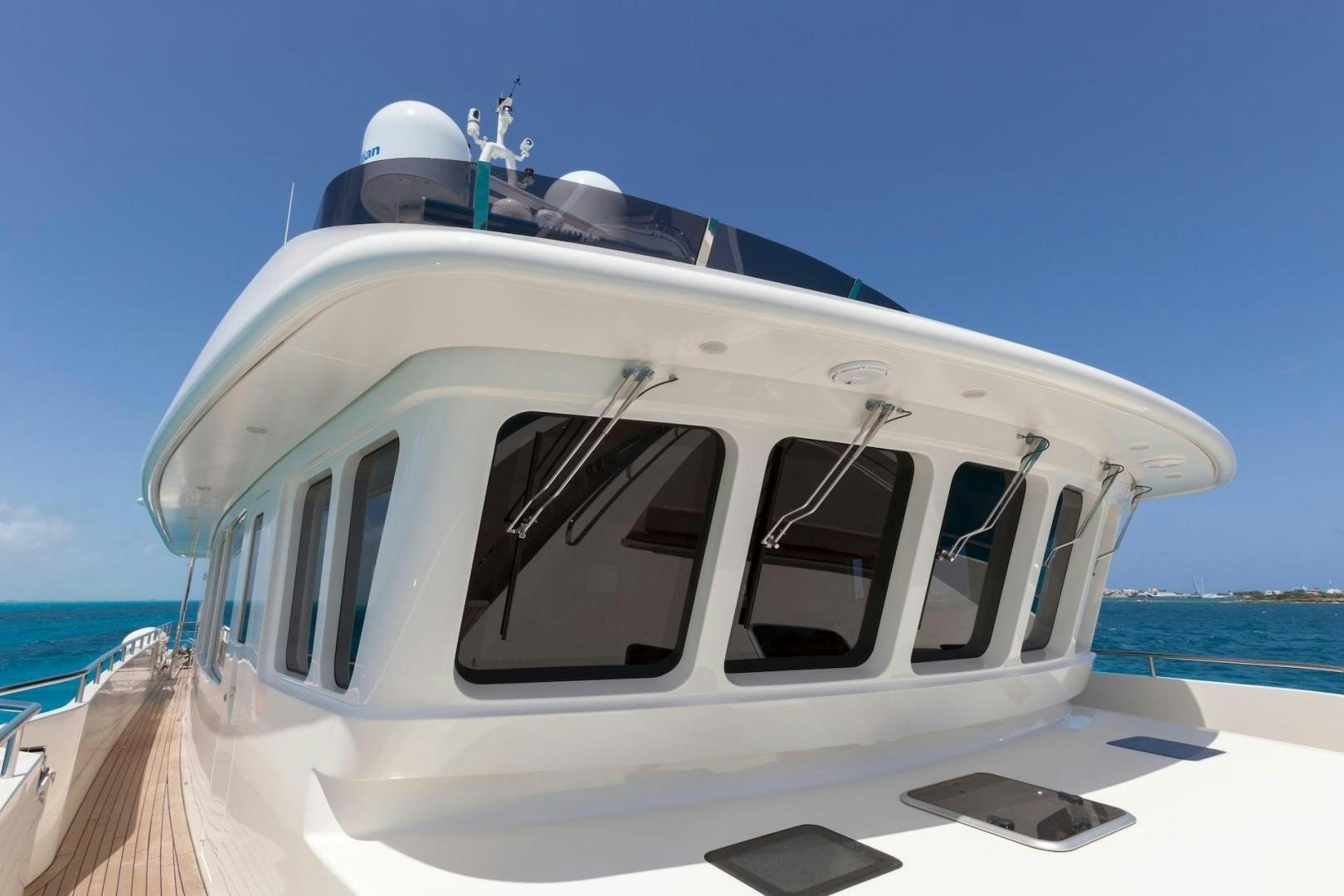 a white yacht on a beach aboard ACALA Yacht for Sale