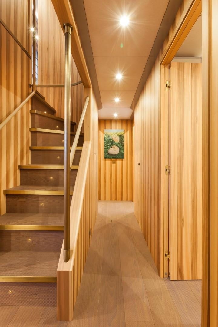 a wooden staircase in a house aboard ACALA Yacht for Sale