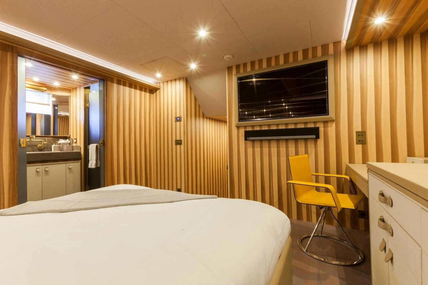 a room with a bed and a chair aboard ACALA Yacht for Sale