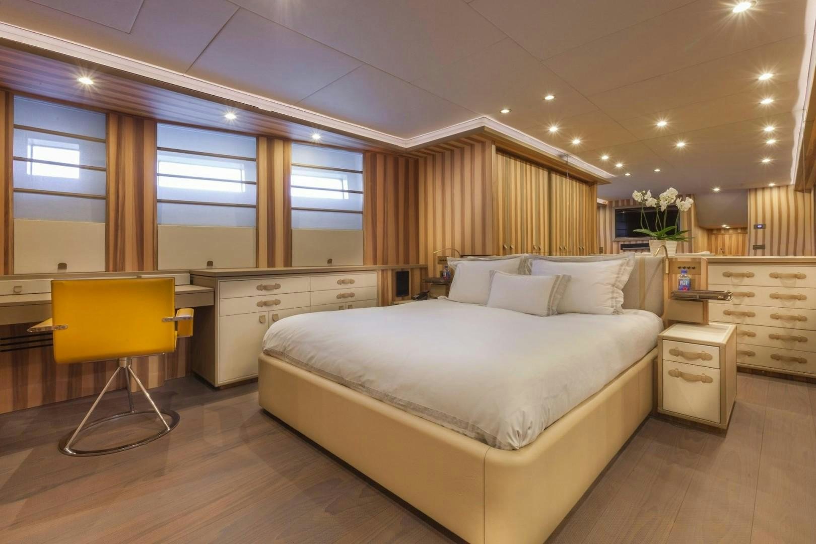 a room with a bed and a desk aboard ACALA Yacht for Sale