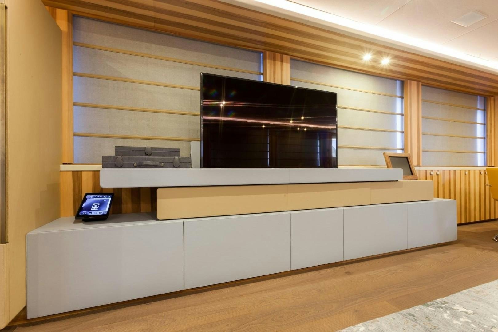 a room with a laptop and a tv on the wall aboard ACALA Yacht for Sale