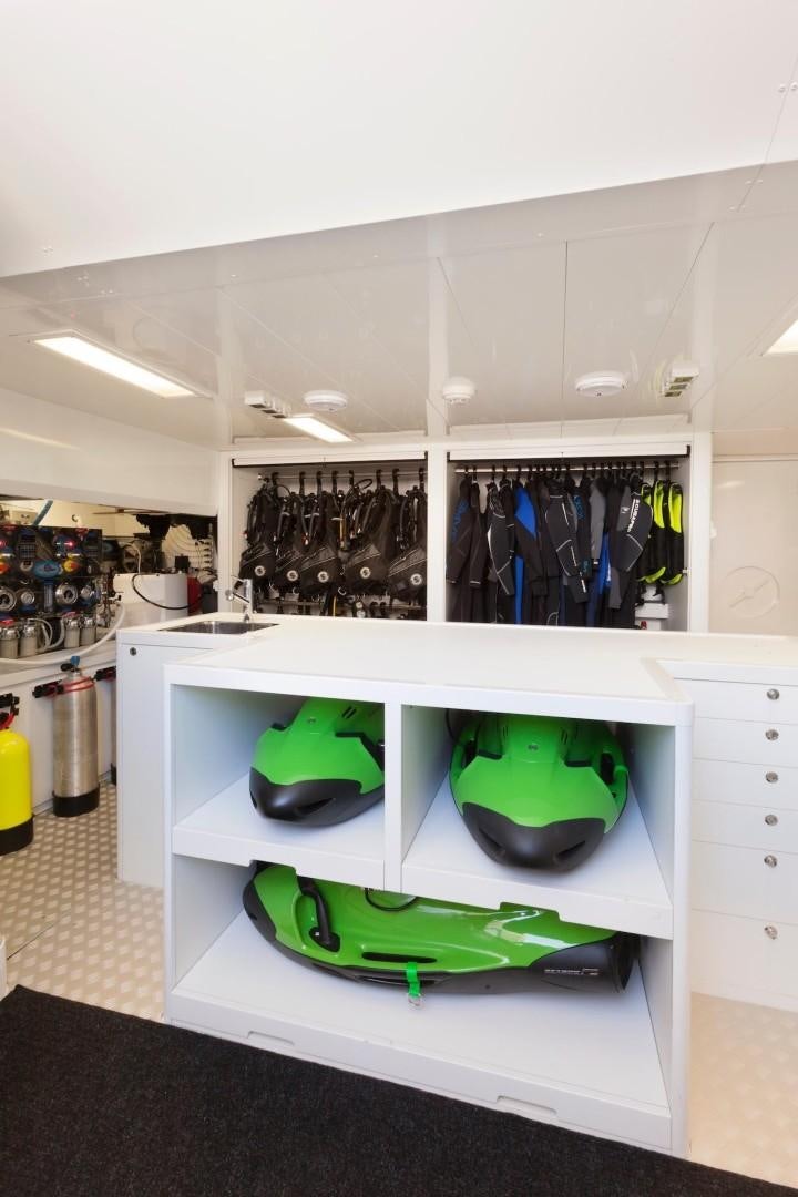 a kitchen with a green and white counter and a green hat aboard ACALA Yacht for Sale