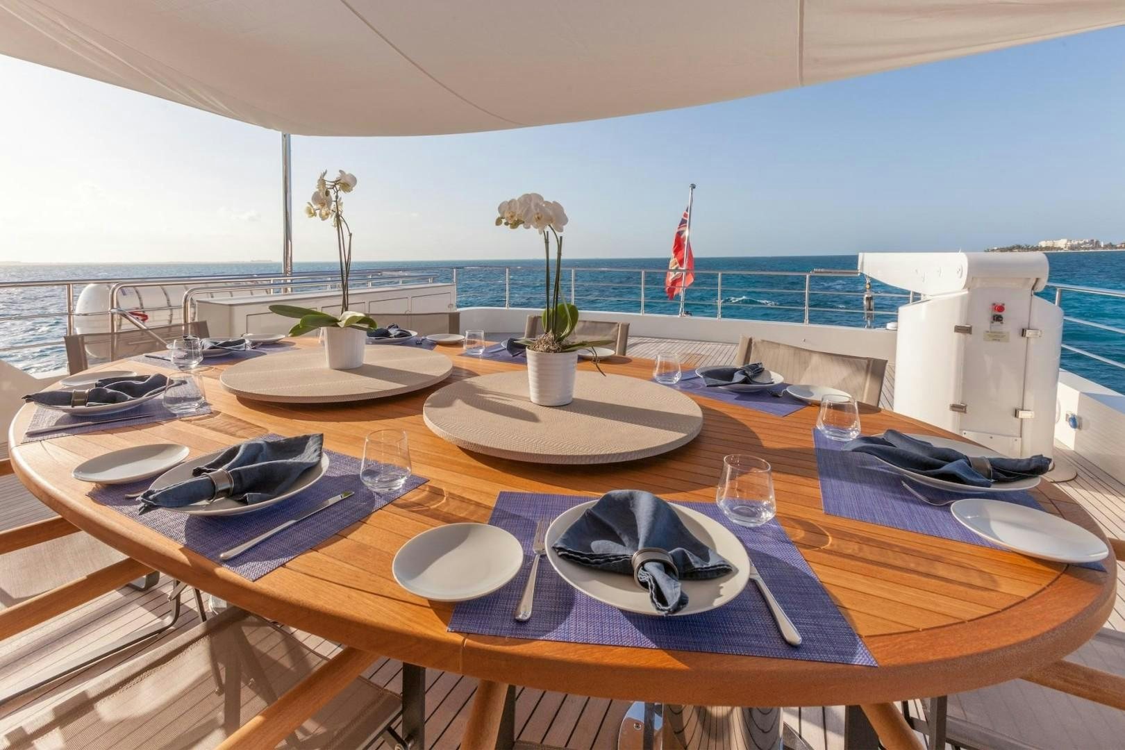 a table with plates and glasses on it aboard ACALA Yacht for Sale