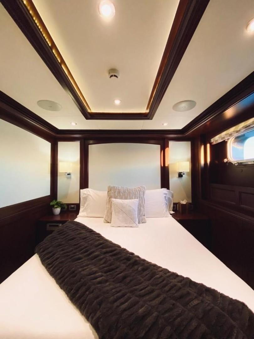 a bed with a white bed spread aboard SAMSARA Yacht for Sale