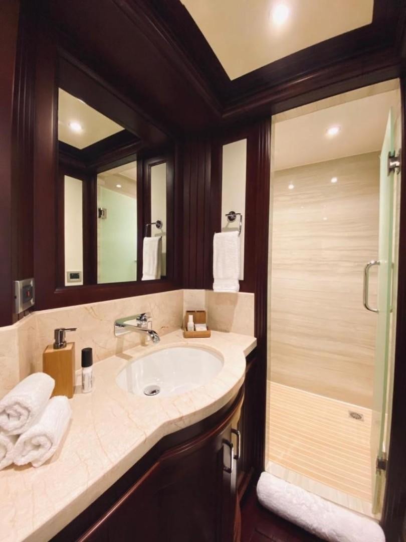 a bathroom with a sink and a mirror aboard SAMSARA Yacht for Sale