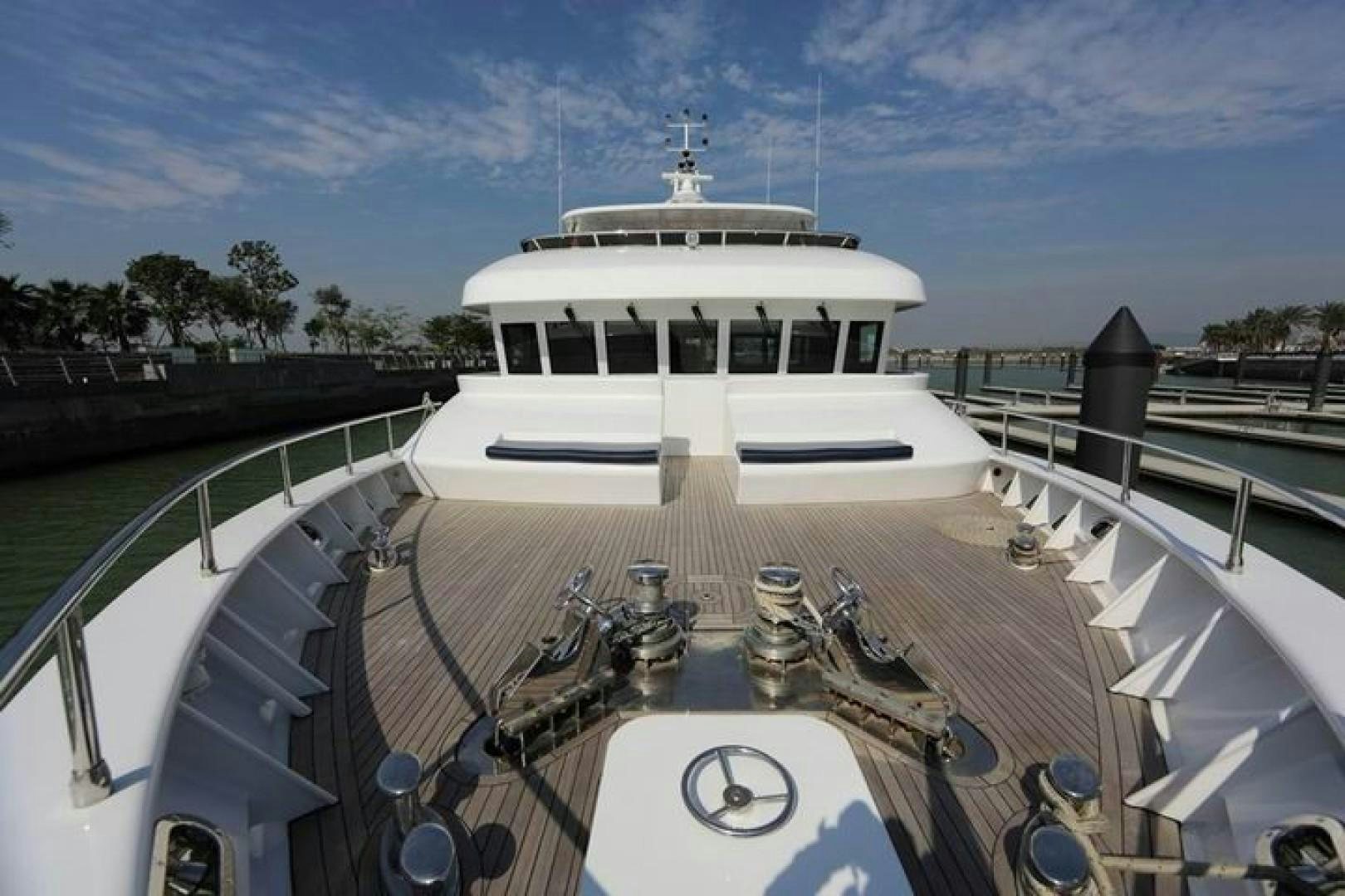 a white boat in a harbor aboard SAMSARA Yacht for Sale