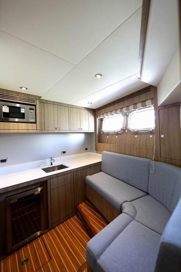 a kitchen with a couch and a sink aboard SAMSARA Yacht for Sale