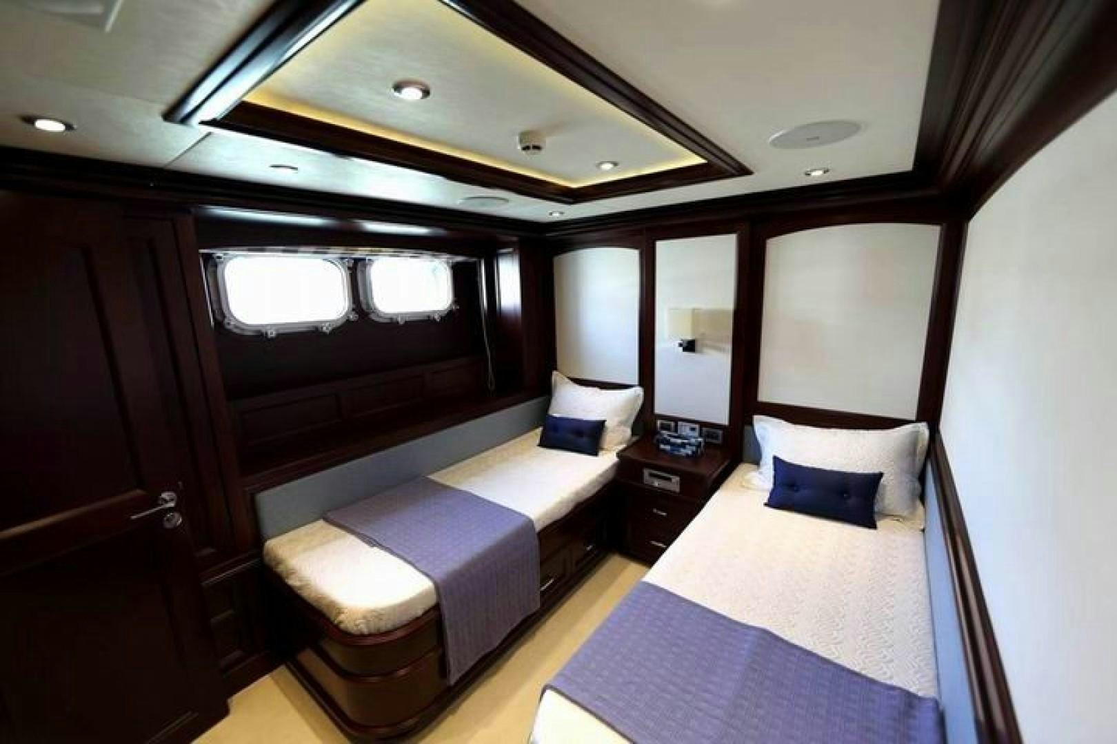 a room with a bed and a desk aboard SAMSARA Yacht for Sale