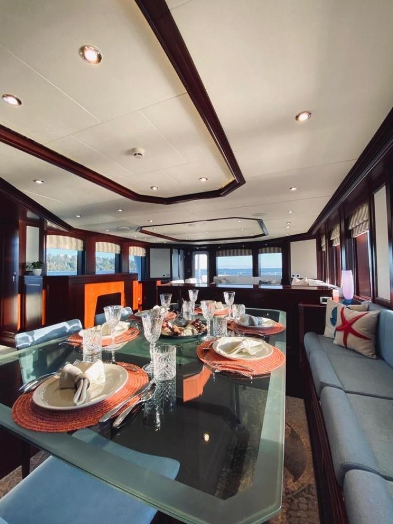 a dining room with a table set aboard SAMSARA Yacht for Sale