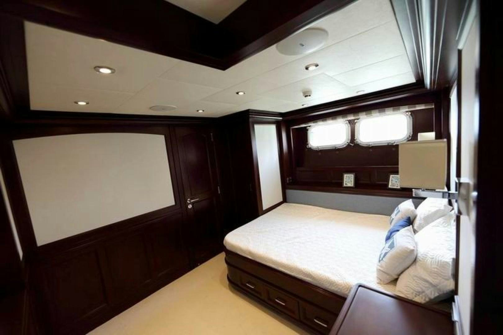 a room with a bed and a desk aboard SAMSARA Yacht for Sale