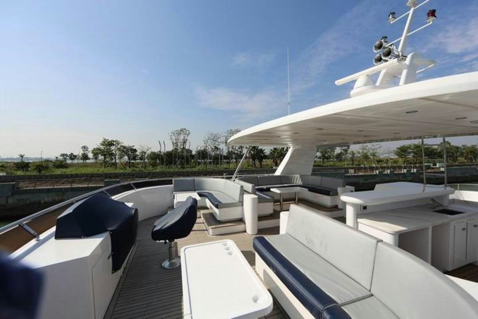 a room with a table and chairs and a wind turbine in the background aboard SAMSARA Yacht for Sale