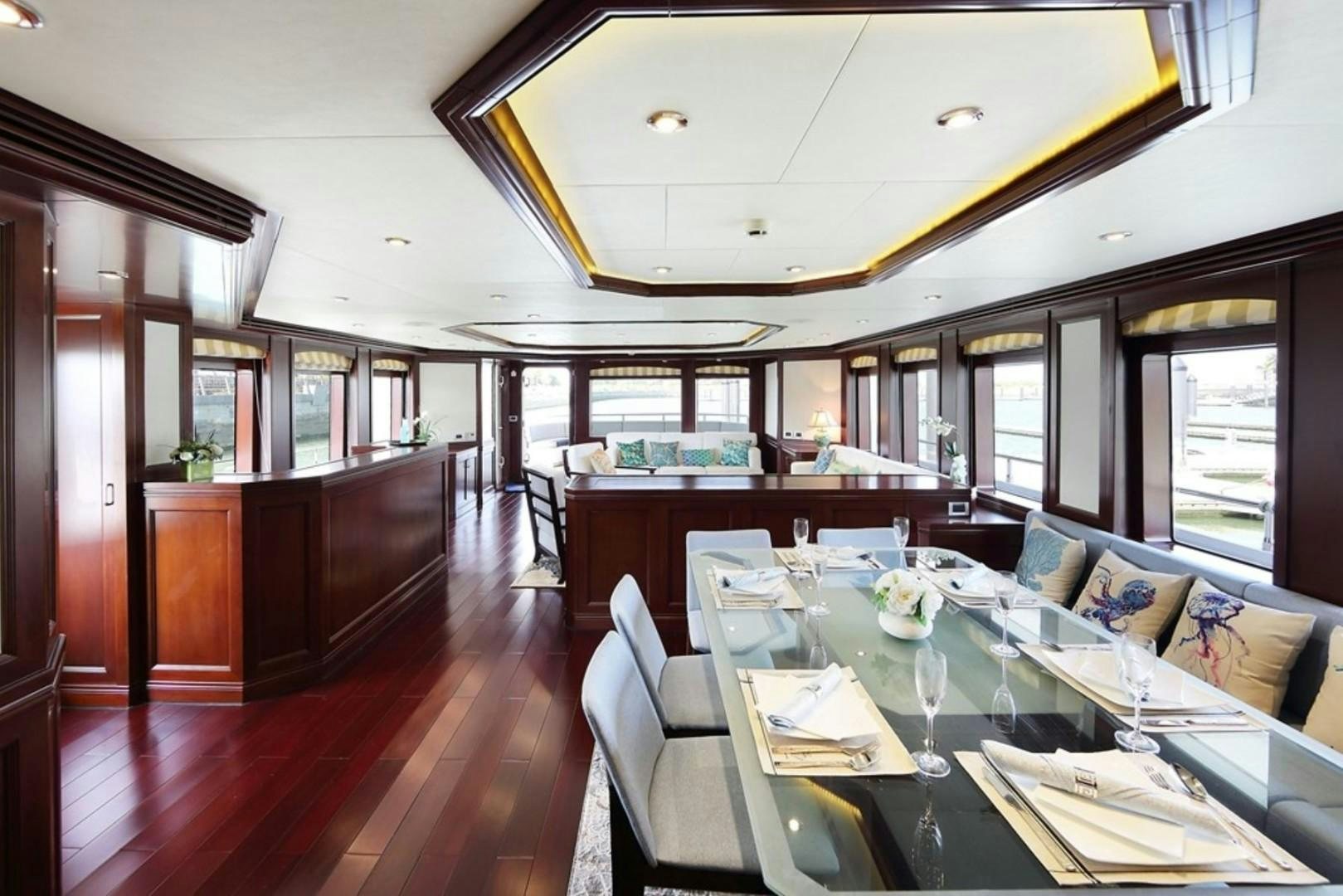 a large dining room with a wood floor aboard SAMSARA Yacht for Sale