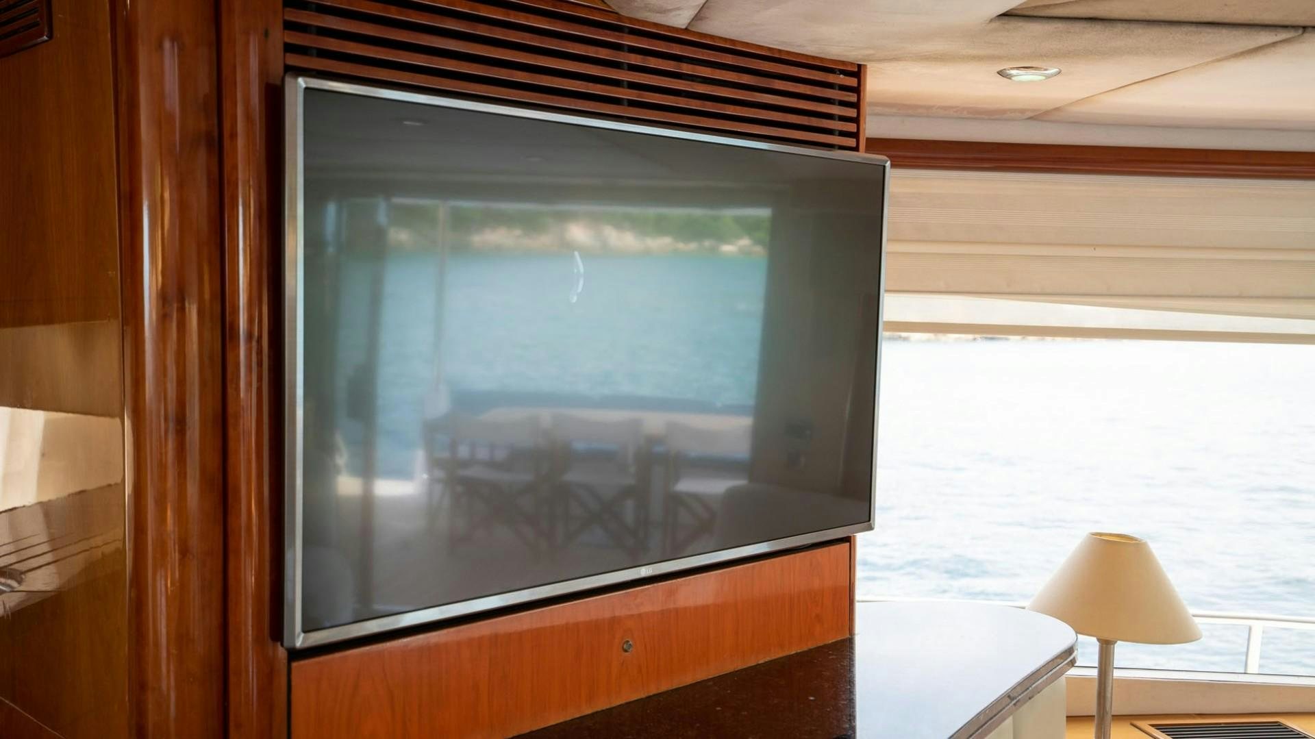 a television on a wooden stand aboard LUCKY Yacht for Sale
