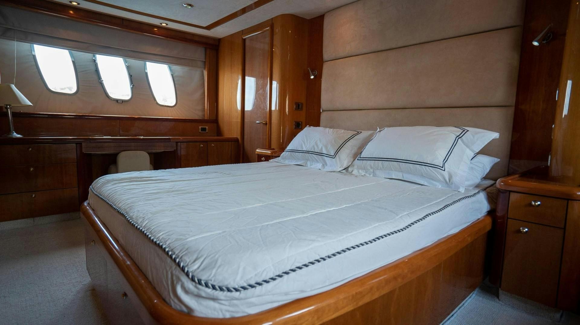 a bed with white sheets aboard LUCKY Yacht for Sale