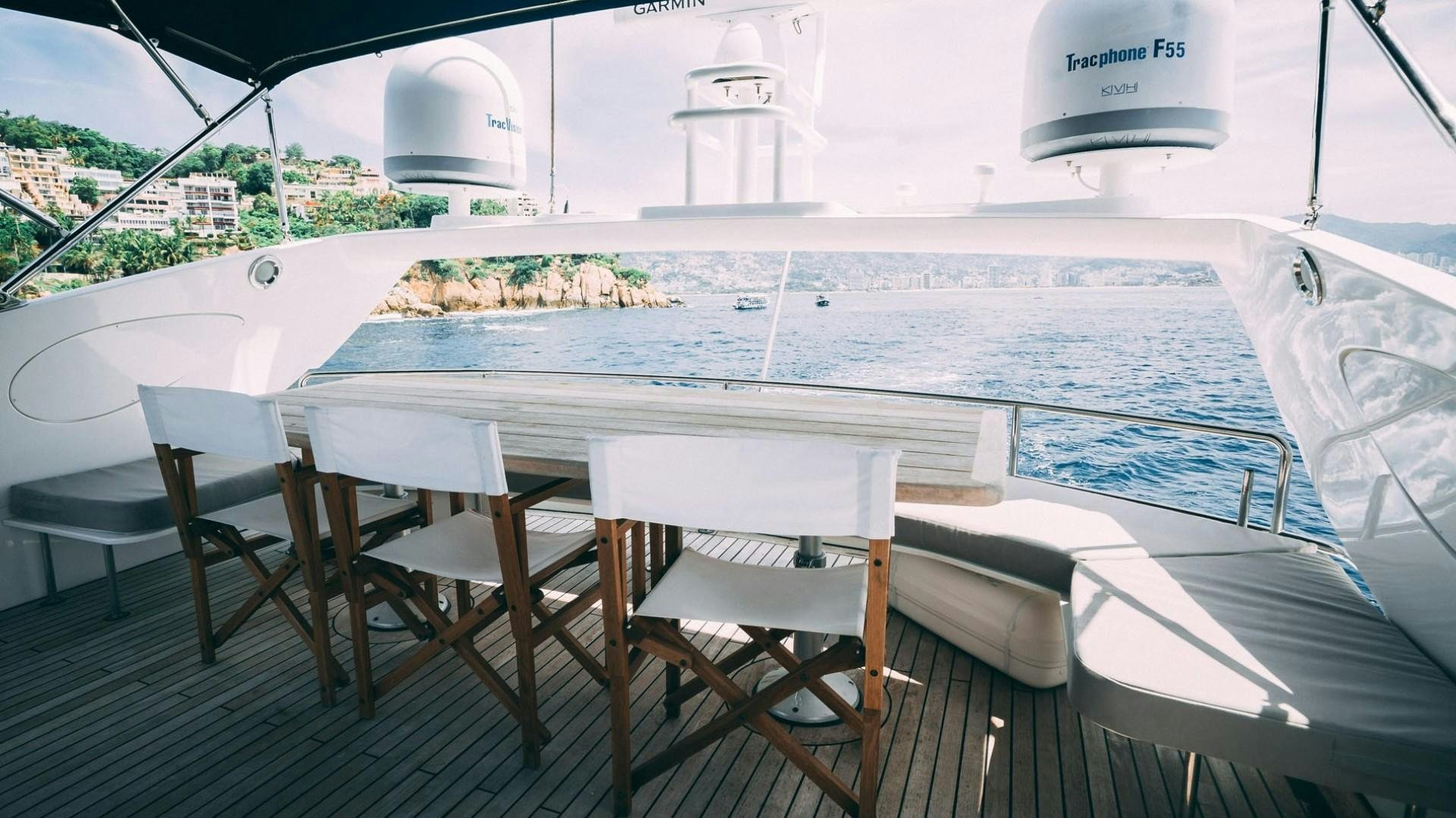 a table and chairs on a deck aboard LUCKY Yacht for Sale