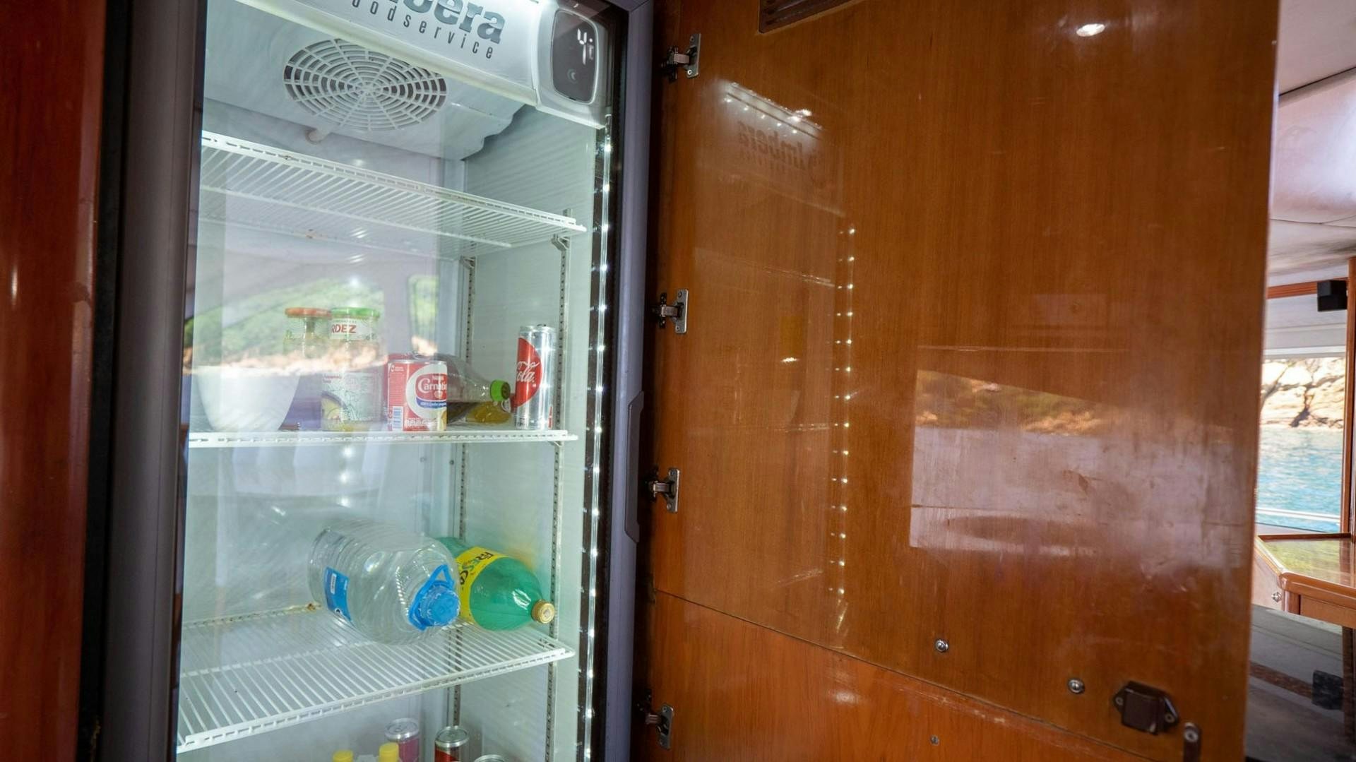 a refrigerator with a door open aboard LUCKY Yacht for Sale