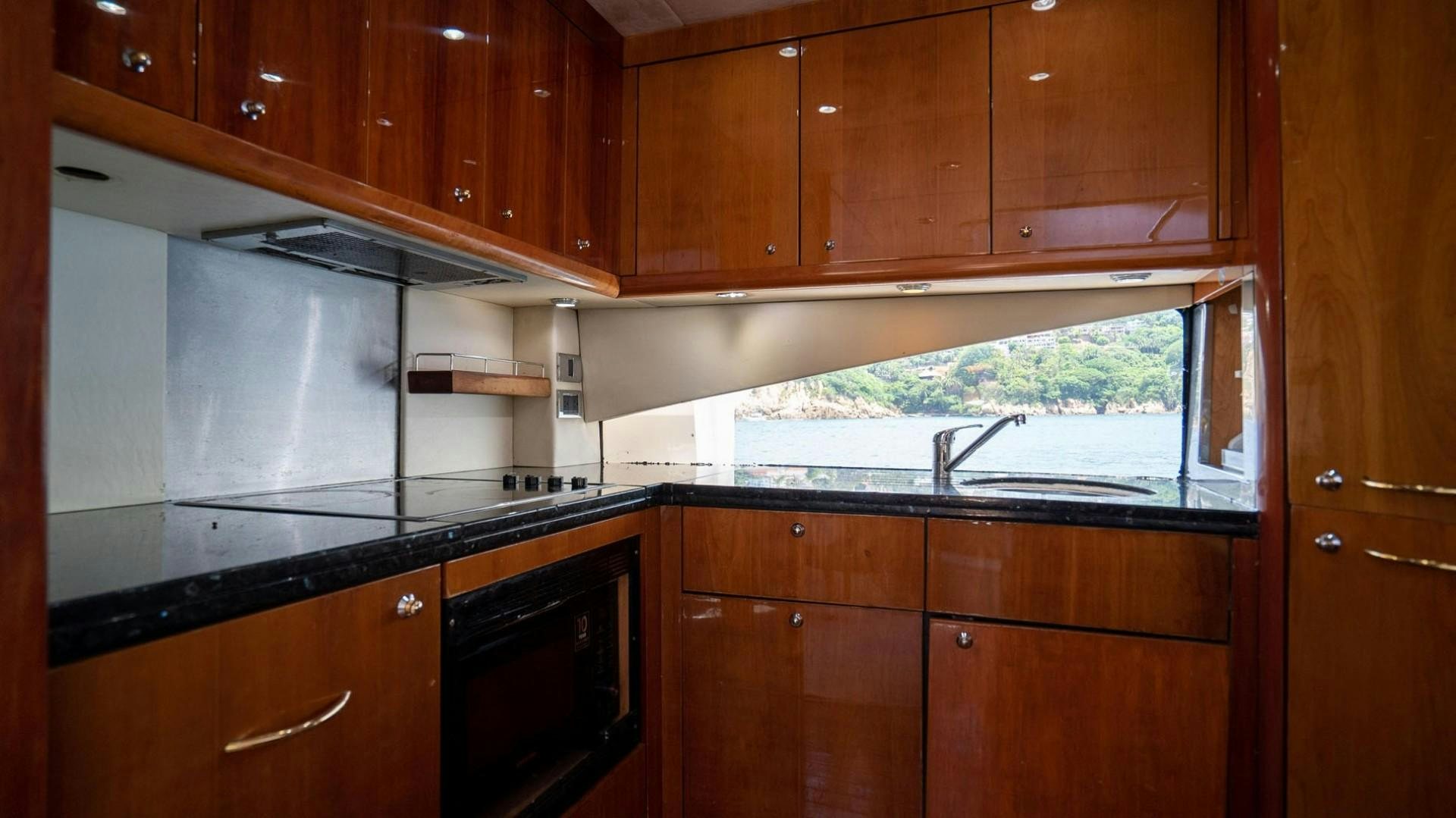 a kitchen with wooden cabinets aboard LUCKY Yacht for Sale