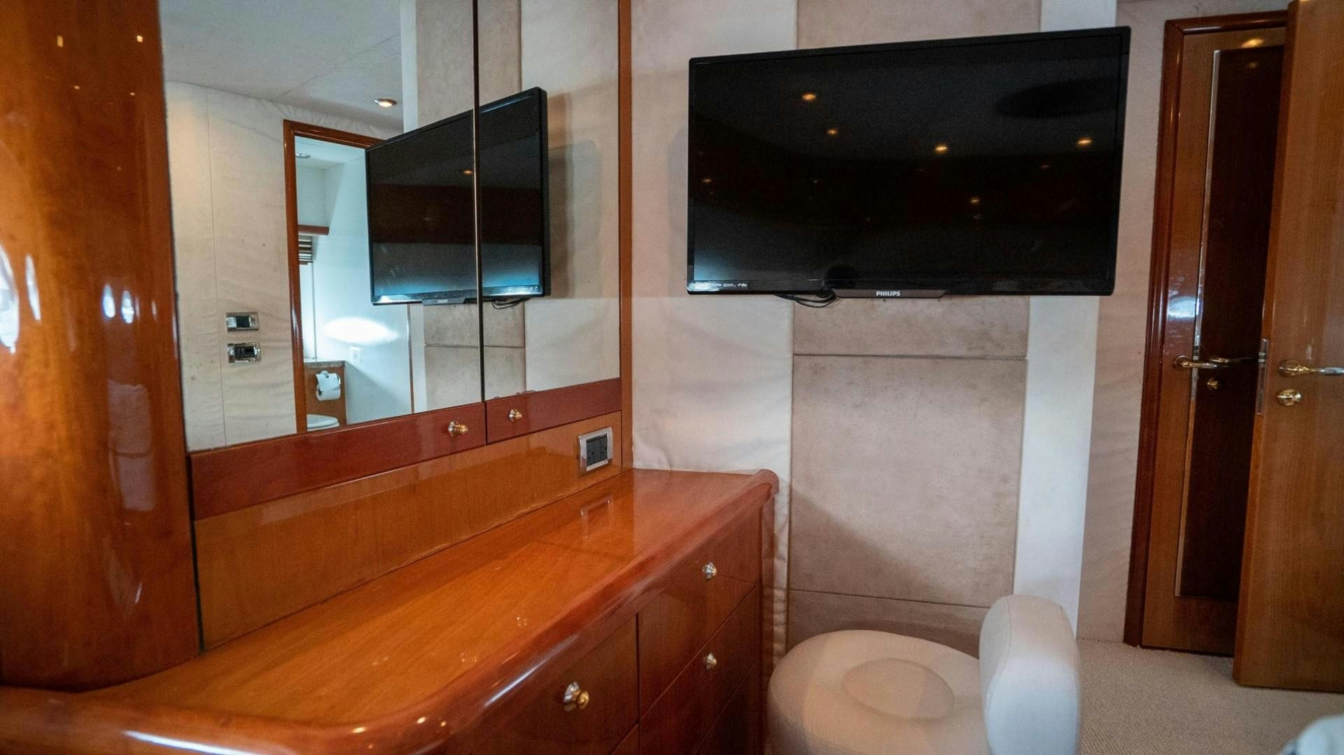a bathroom with a toilet and a mirror aboard LUCKY Yacht for Sale