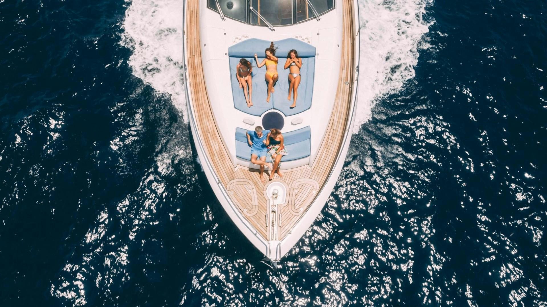 a white and gold coin with people on it aboard LUCKY Yacht for Sale
